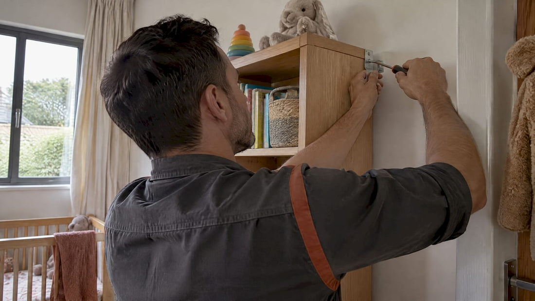 Homeowner fastening a bookcase to a wall stud